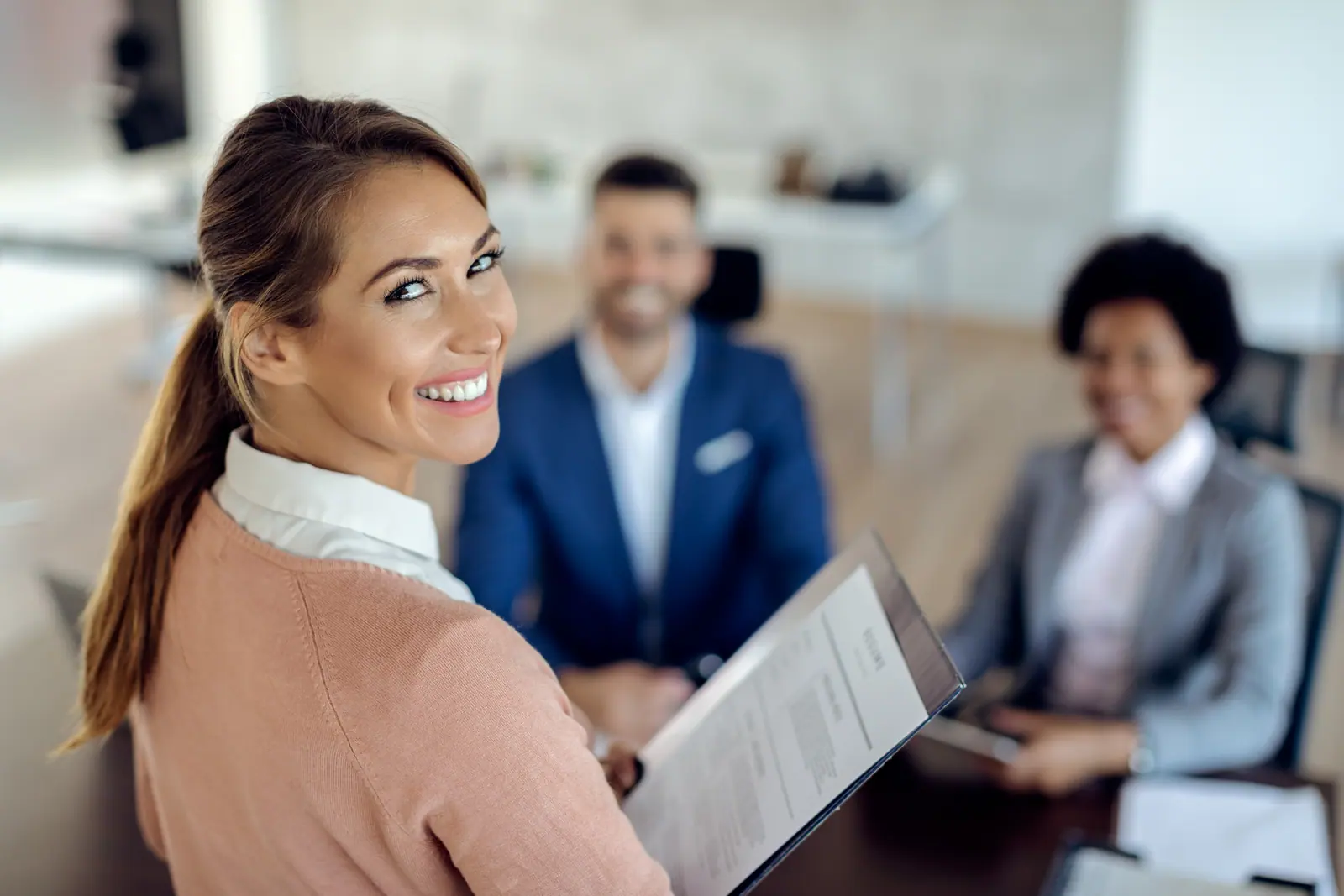 A smiling colleague in a team meeting