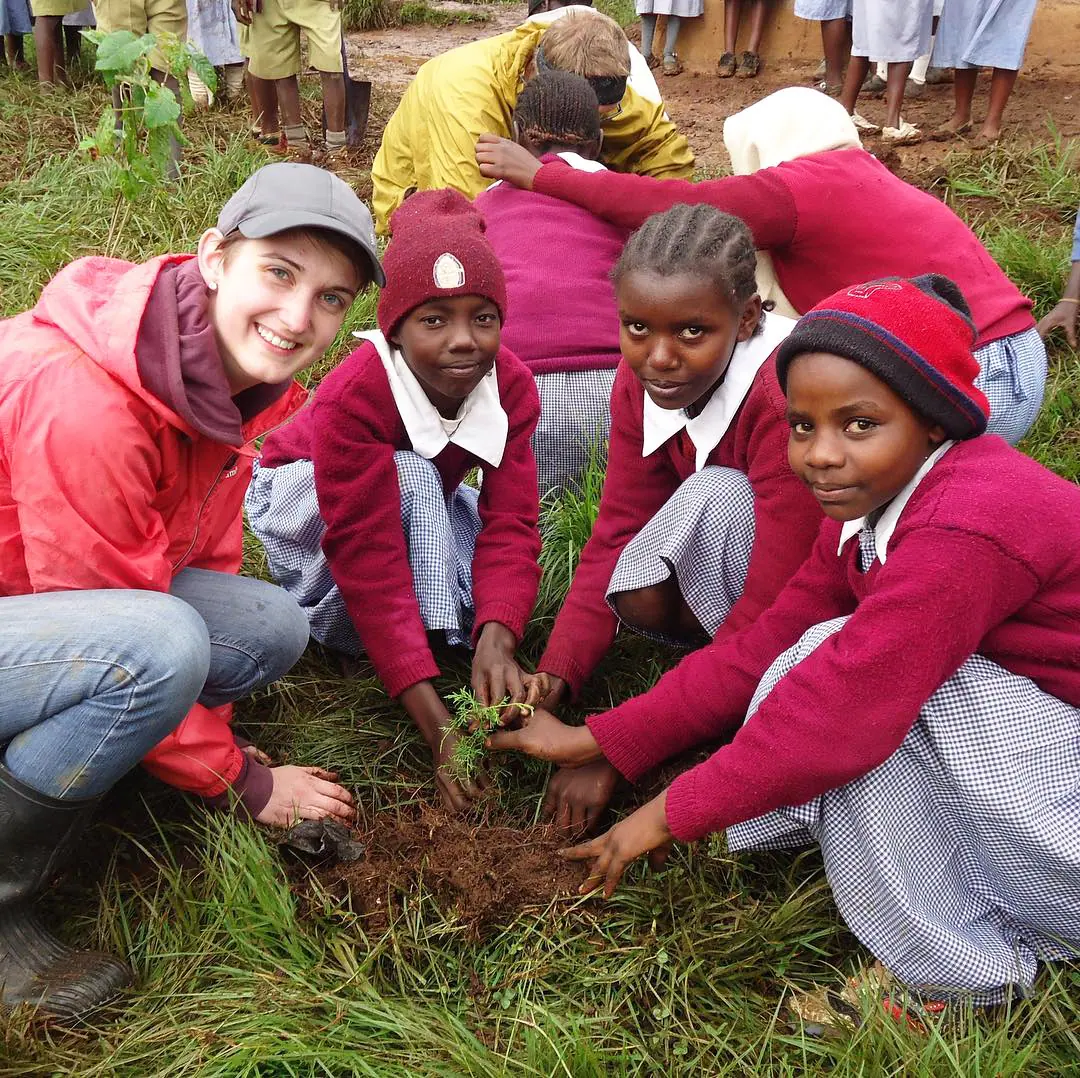 Volunteers and students planting together