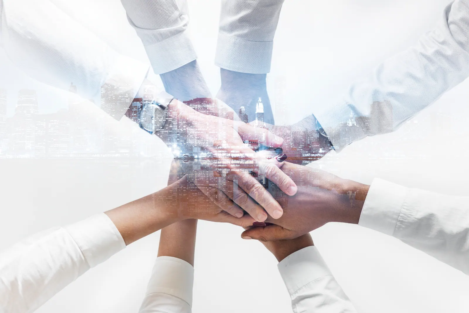 Many hands joined together in partnership