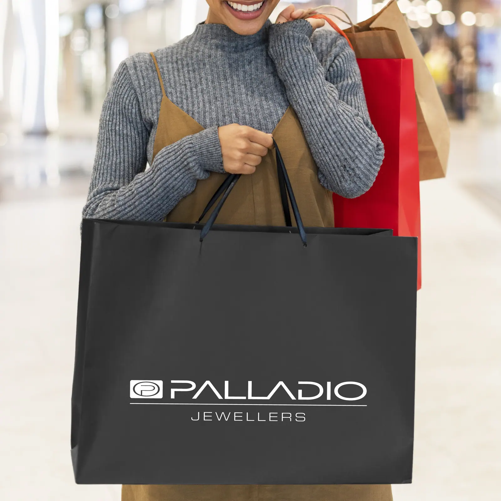 A client carrying a Palladio Jewellers paper shopping bag