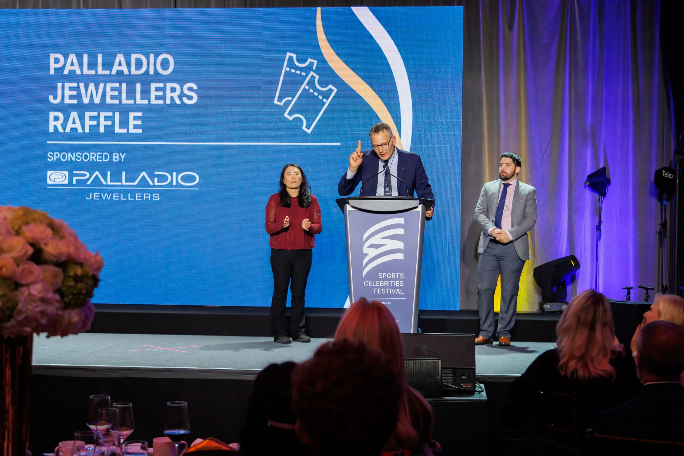 Jason Bosa at the podium for the Palladio Jewellers raffle at the Sports Celebrities Festival