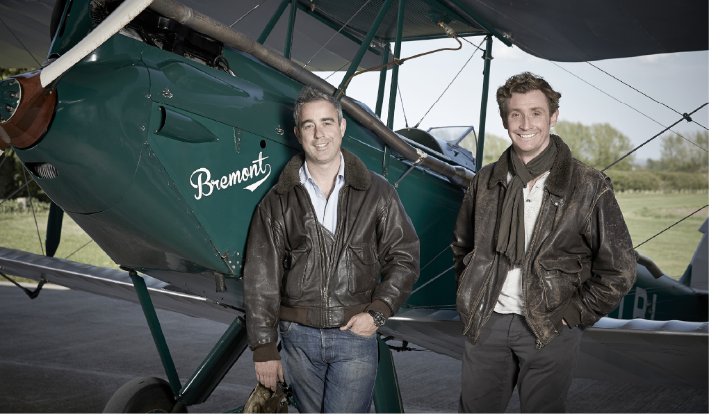 Bremont founders Nick and Giles English standing by vintage aircraft - Bremont at Palladio Jewellers Vancouver