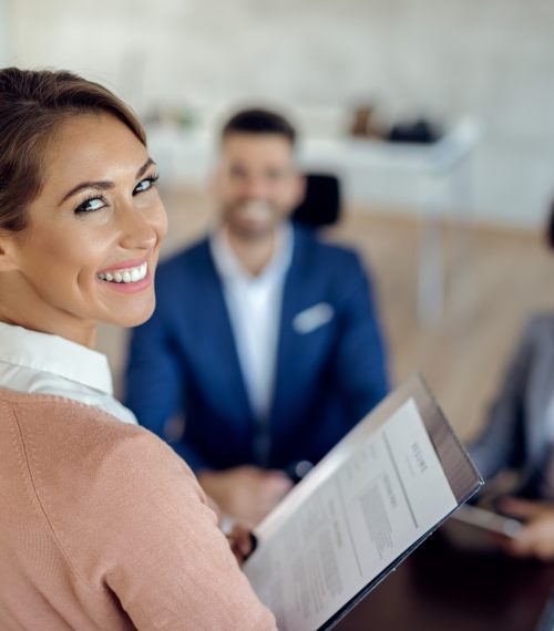 Young happy woman having an job interview in the office. Happy woman applying for job in the office and looking at the camera.