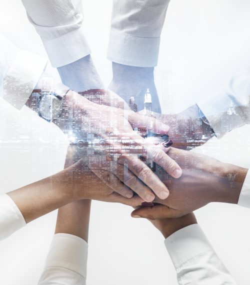 Business team joining hands together city background Business team joining hands together city background